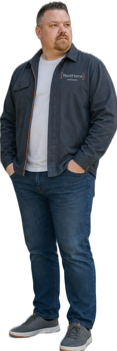 Cory Short standing outside an Asheville home in NextHome Partners gear